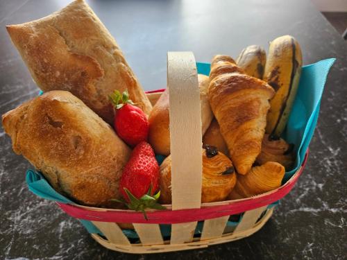 a basket filled with pastries and strawberries on a table at Millésime in Perville