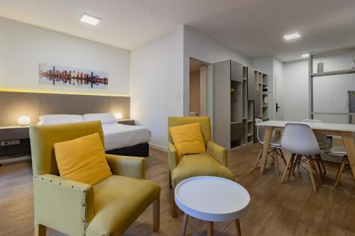 a hotel room with a bed and a table and chairs at Live Soho Boutique & Apartments Palermo Soho II in Buenos Aires