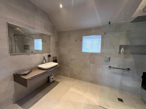 a bathroom with a sink and a shower at Woodhouse Retreat in Woodhouse