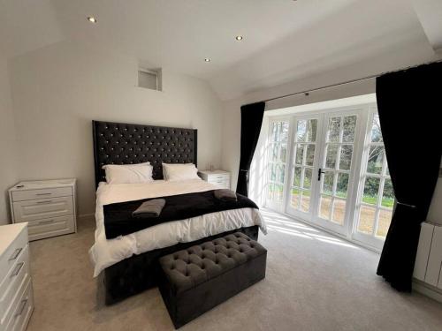 a bedroom with a large bed and a large window at Woodhouse Retreat in Woodhouse