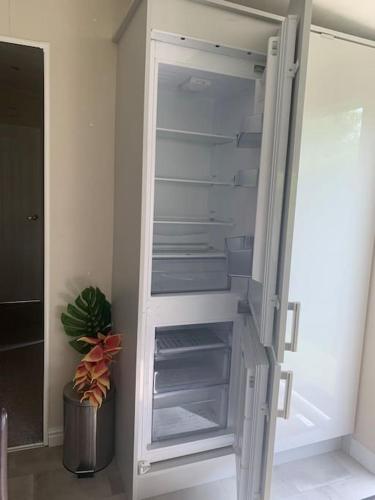 a white refrigerator with its door open in a room at Luxury spacious house with two bathrooms at park with swimming pools, restaurant, bowling, massage & wellness in Voorthuizen