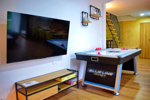 a game room with a pool table and a flat screen tv at Chalupa Martinček in Terchová