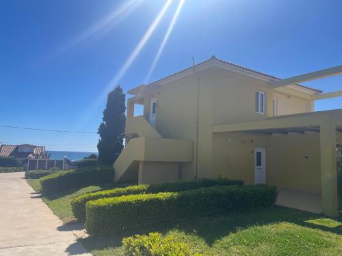 a house with a staircase in front of it at Boutique Hotel Ileas Village in Arkoudi