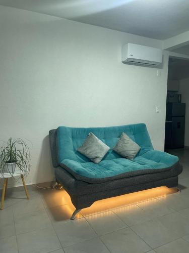 a blue couch in a living room with a light at Acapulco Dreamer Diamante II in Gallinero