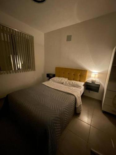 a small bedroom with a bed in a room at Acapulco Dreamer Diamante II in Gallinero