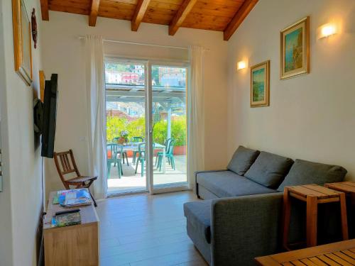 a living room with a couch and a table at Villa Livia - L'Opera Group in La Spezia