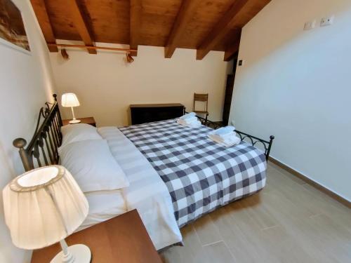 a bedroom with a bed and a table with a lamp at Villa Livia - L'Opera Group in La Spezia