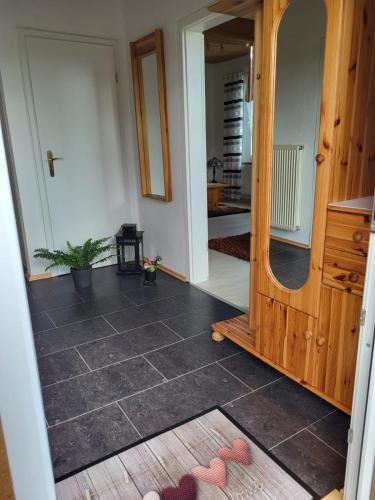 a hallway with a mirror and a floor at Ferienwohnung Emira in Wittingen