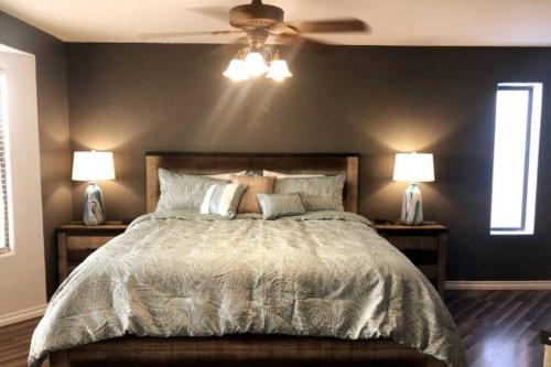a bedroom with a large bed with two lamps at The Gentleman's Jack in Parker