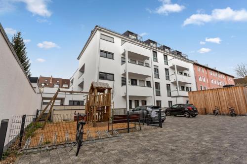 a white building with scaffolding in a parking lot at MT Living - private Terasse - Whirlpool in Aschaffenburg