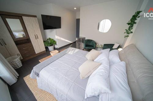 a bedroom with a large bed with white pillows at Beautiful Studio in Barranco in Lima