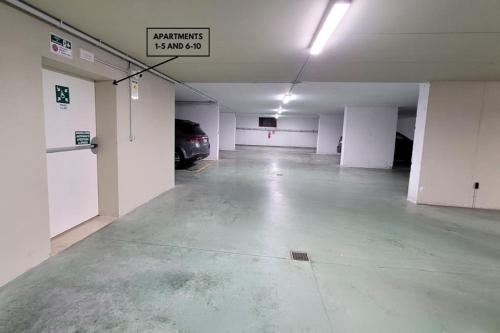 an empty parking garage with a car parked in it at Appartamenti Annachiara in Costermano sul Garda