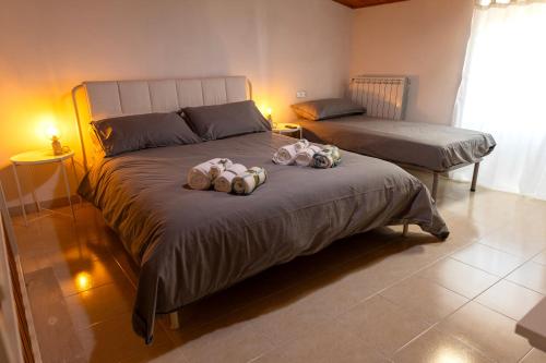 two stuffed animals sitting on a bed in a bedroom at Casa Schioppo - Molise fells like Home in Carpinone