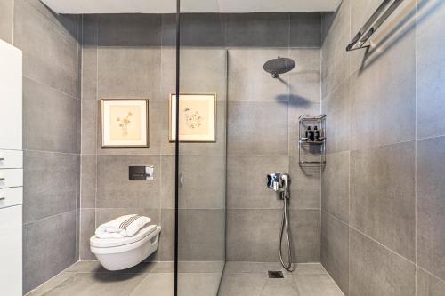 a bathroom with a shower with a toilet in it at Iconic PRIVE beachfront villa Mola Kaliva in Mola Kalyva