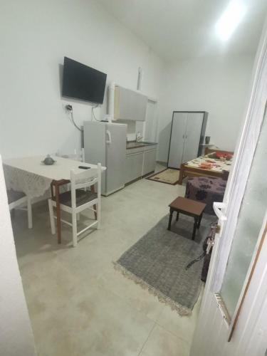 a room with a kitchen with a table and a tv at T.I.M.2 in Bela Crkva