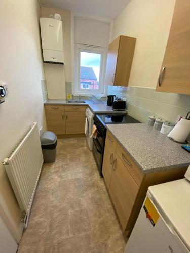 a kitchen with a sink and a counter top at 1 bed Flat ''Beta'' in Dewsbury road, Leeds in Hunslet