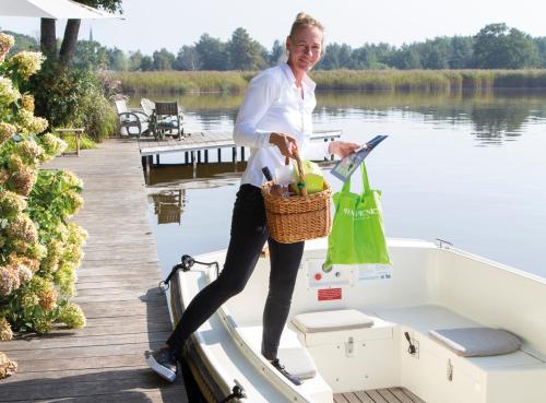 a woman standing on the bow of a boat at Restaurant-Hotel de Watergeus in Noorden