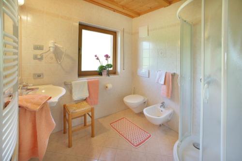 a bathroom with a sink and a toilet and a shower at Garni Sonneck in Laion