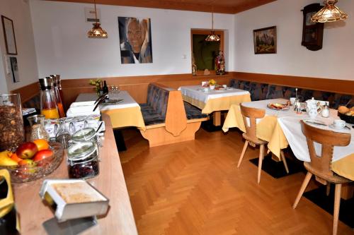 a dining room with two tables in a restaurant at Garni Sonneck in Laion
