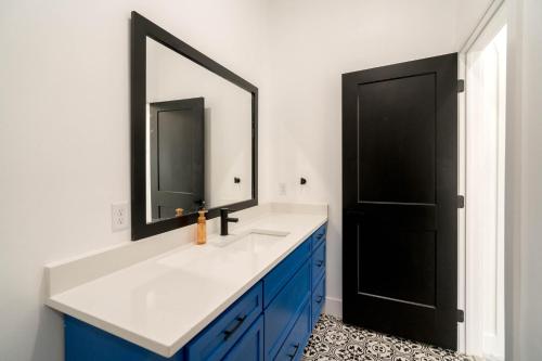 a bathroom with a blue and white sink and a mirror at Perfect Spacious Modern Home w/Hot Tub in San Antonio