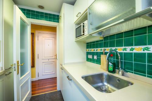 a kitchen with a sink and green tiles at GETXO II (Downtown, Beach and Parking) 15Min BILBAO By GrupoZTK in Getxo