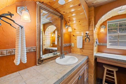 a bathroom in a cabin with a sink and a mirror at Dog-Friendly 3BR on 200 Acres w/ River Access in Sloat