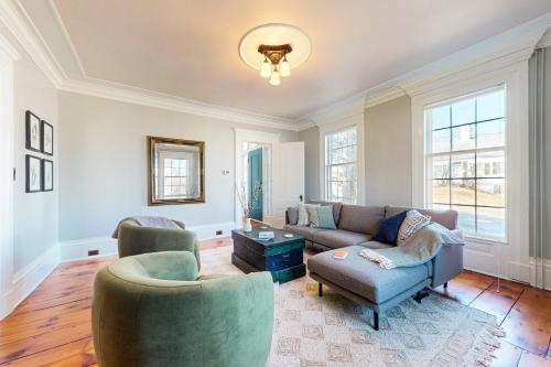 a living room with a couch and two chairs at Belfast Victorian in Belfast