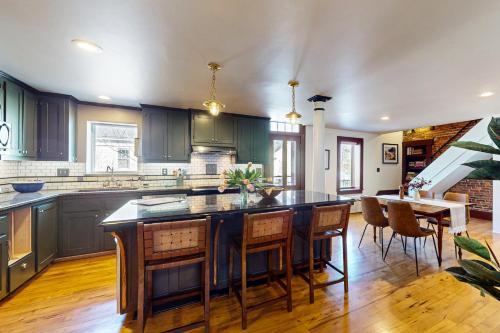 a kitchen with blue cabinets and a table and chairs at Belfast Victorian in Belfast