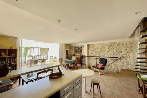 a large living room with a table and chairs at Village house Stella in Saint-Cannat