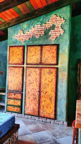 a wall with orange doors on the side of a building at Casa Gaudi - House & Rooms in Teulada