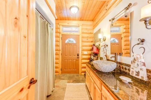a bathroom with a sink and a shower and a mirror at Mountain Cabin with Hot Tub 4 Mi to Shaver Lake! in Shaver Lake