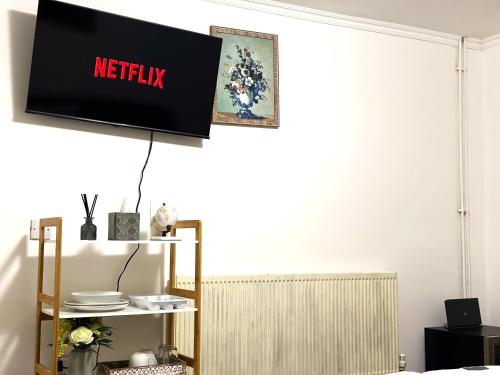 a television hanging on a wall in a living room at Comfy Room in Nottingham in Nottingham