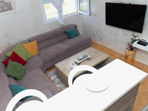 a living room with a couch and a tv at Apartment Kosta in Podgorica