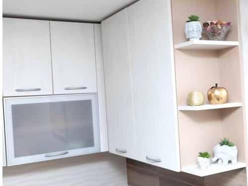 a white kitchen with white cabinets and shelves at Apartment Kosta in Podgorica