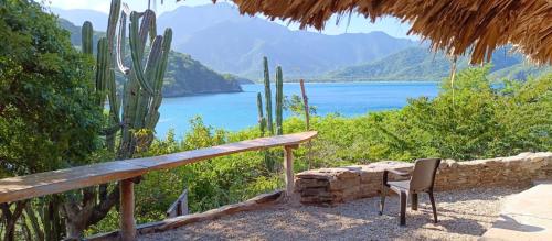a bench with a view of a lake and mountains at Mirador Playa Cristal Tayrona in Santa Marta