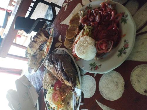 a table with a plate of food with eggs and bread at Mirador Playa Cristal Tayrona in Santa Marta