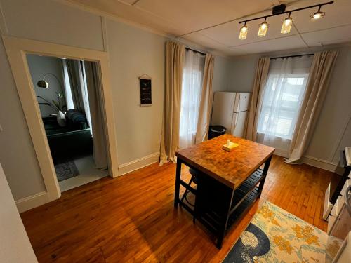 a living room with a table and a refrigerator at Charming & Newly Renovated 2BR in St Albans in Saint Albans