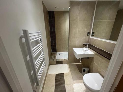 a bathroom with a toilet and a sink at AO Arena flat Manchester, with parking in Manchester