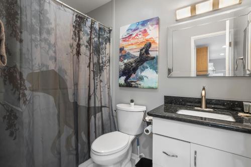 a bathroom with a toilet and a shower curtain at KING BED Well-Located Cozy Townhouse Retreat in Gulfport