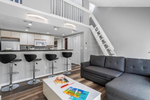 a living room with a couch and a table at KING BED Well-Located Cozy Townhouse Retreat in Gulfport