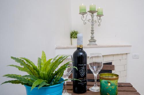 a bottle of wine on a table with a plant at The Spirit Of Tzfat Villa in Safed