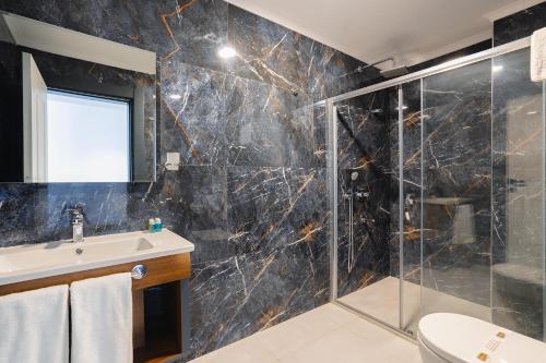 a bathroom with a sink and a shower at Berlin Suite Hotel Trabzon in Trabzon