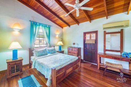 a bedroom with a bed and a wooden ceiling at 2-Story Townhome with Private Pool, Ideal for Group! in Christ Church