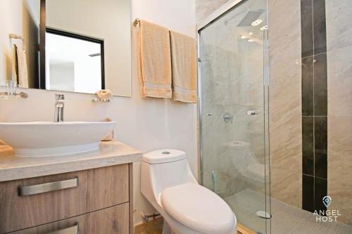 a bathroom with a toilet and a sink and a shower at New Townhome Private Patio Parking Pool Onsite in La Paz