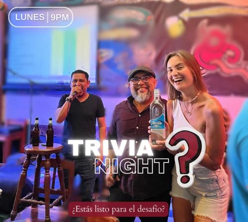 two men and a woman standing next to a microphone at ViaVia Leon in León