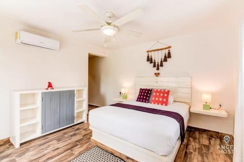a bedroom with a bed and a ceiling fan at A Sublime Beach Getaway Perfect for a Family Gathering in El Cuyo