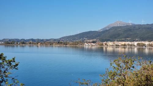 a large body of water with mountains in the background at Place 2 Be in Nafpaktos