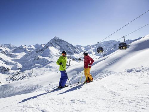 two people standing on a ski lift in the snow at Mamalisl in Mittersill