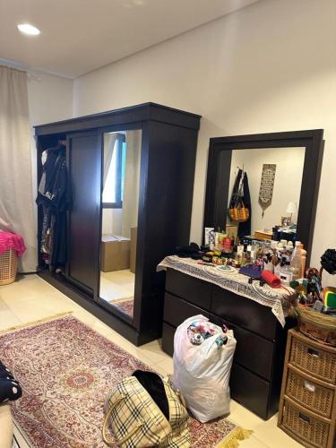 a dressing room with a vanity and a large mirror at Hash&Jazz in Manama