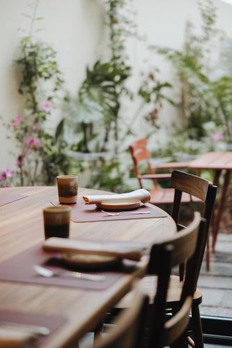 a wooden table with a napkin on top of it at NINE DOTS Azorean Art Boutique Hotel in Ponta Delgada